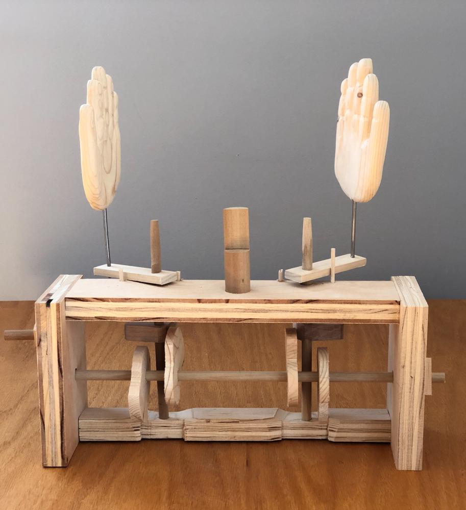 Peek-a-boo machine with hands wide