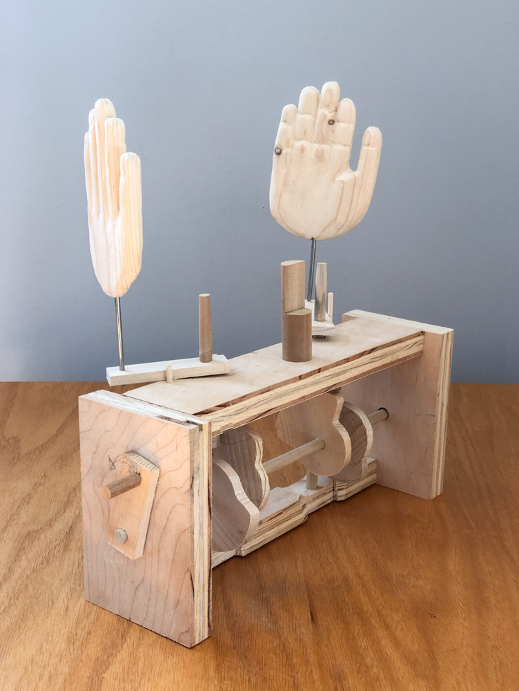 Peek-a-boo machine with hands wide